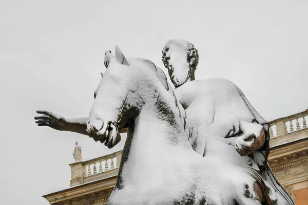 Frozen roman emperor. Marcus Aurelius bronze statue on Capitoline Hill covered by snow, a very rare event in Rome