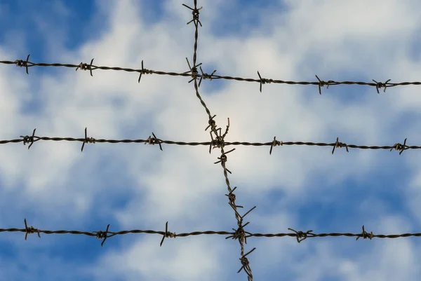 Barbed wire and clouds background — Stock Photo, Image