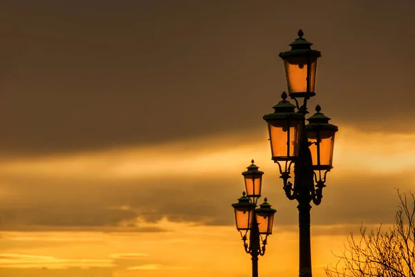 Venetian  lamps with golden sunset sky — Stock Photo, Image