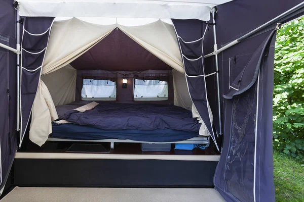 Camping or glamping with a real bed with mattress in a tent