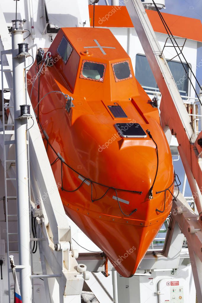 Modern orange lifeboat on a ship moored in Rotterdam in the Netherlands