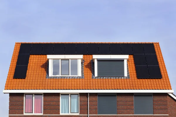 Neighbors with different lifestyles in the Netherlands. Contemporary rolling security shutters instead of curtains