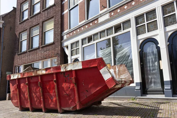 Red skip in a street in Rotterdam