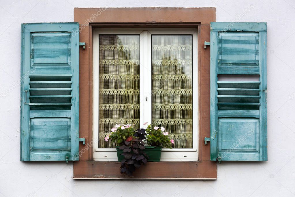 Vintage window with blue shutters
