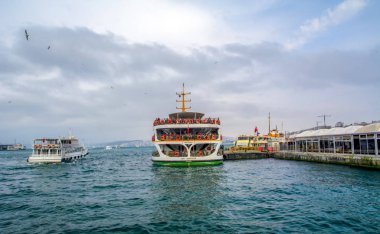 İstanbul, Türkiye 03 Nisan 2019: Türkiye'de Müslüman mimarisi ve su taşımacılığı - İstanbul Boğazı'nda deniz yolculuğundan gelen turistik manzaralar. Gün batımında İstanbul Şehir Manzarası - eski cami ve türk vapurları, Haliç manzarası.