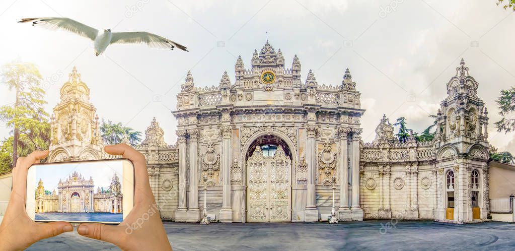 Tourist taking a picture in front of   Dolmabahce Palace Istanbul, Turkey. Travel concept