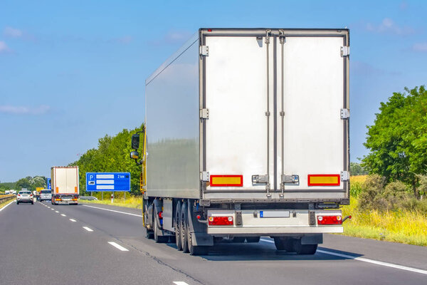 Truck with container on highway, cargo transportation concept.