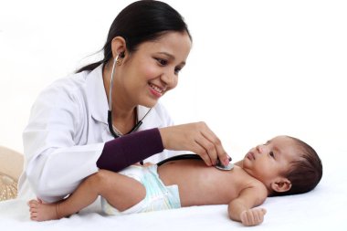 Cheerful female pediatrician holds newborn baby clipart