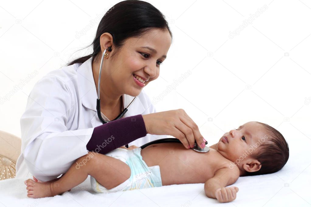 Cheerful female pediatrician holds newborn baby