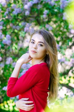 Bahar genç kadın portresi heyecandır. Leylak arka plan üzerinde bir kız portresi. Dikey fotoğraf.