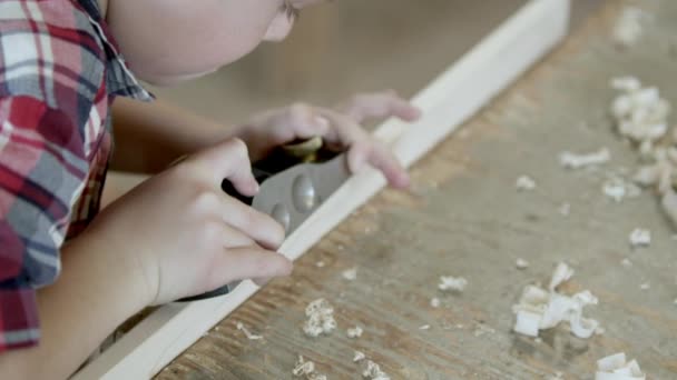 ボード上の手の平面を使用して木材店で若い男の子 — ストック動画