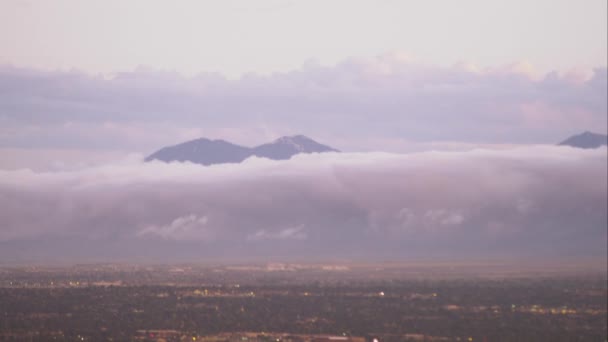 Panning shot of the Salt Lake Valley with clouds clinging to the mountains.