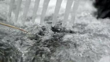 Küçük bir derede süzülen buz saçaklarının görüntüsüne yakınlaştım..