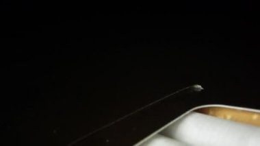 Sigara filtreleri ile ilgilenen yakından siyah kutusunda üst üzerinde hareket.