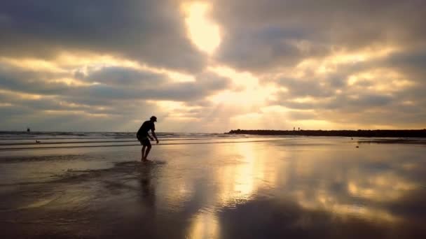 Mann Dreht Sich Bei Farbenfrohem Strandblick Von Oben Auf Skimboard — Stockvideo