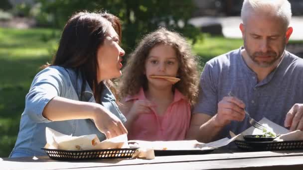 Los Padres Que Hablan Mientras Hacen Picnic Cuando Niña Intenta — Vídeos de Stock