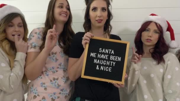 Women Holding Blackboard Words Santa Have Been Naughty Nice — Stock Video