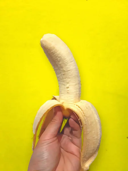 Peeled banana on yellow — Stock Photo, Image