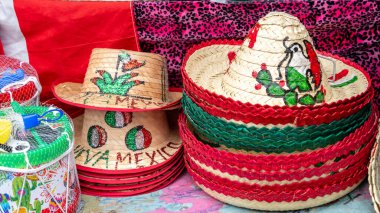A collection of hats with the word Mexico on them. The hats are arranged in a row and are displayed on a table