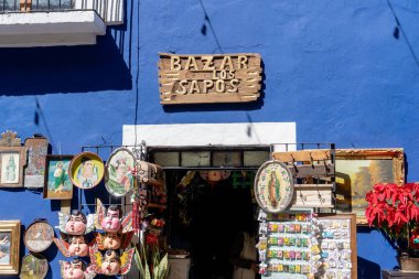 A blue building with a sign that says 