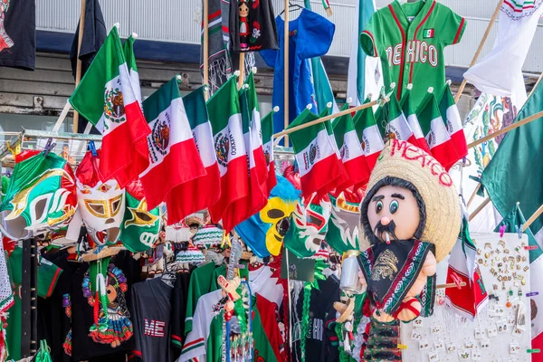 A display of flags and a mannequin wearing a sombrero. The flags are in various colors and sizes. Decoration to celebrate Independence Day in Mexico, zocalo
