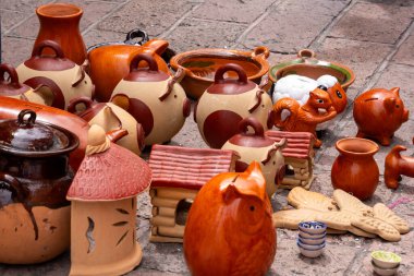 A collection of pottery and ceramic items, including a variety of vases and bowls, are displayed on . Historic center of Queretaro City, decorations and traditions to celebrate Mexico's Independence Day, colonial architecture, alleys and facades