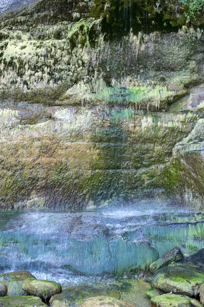 Limestone cave wall with dripping water and stalactites for backgrounds