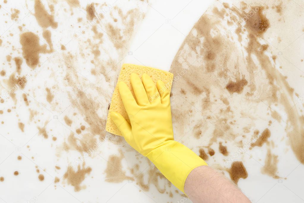 Gloved Hand WIping a Dirty Counter or Floor with Sponge