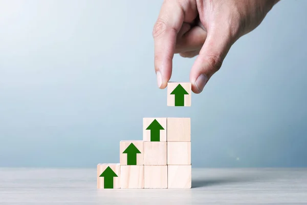 Wood block cubic stacking step up with Green Arrow Blue Tone. Business growth success process. Business Concept. Up Trend.