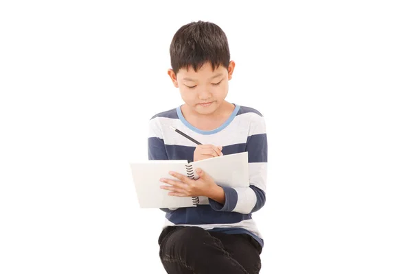 Aziatische Jongen Schriftelijk Actie Geïsoleerd Witte Achtergrond — Stockfoto