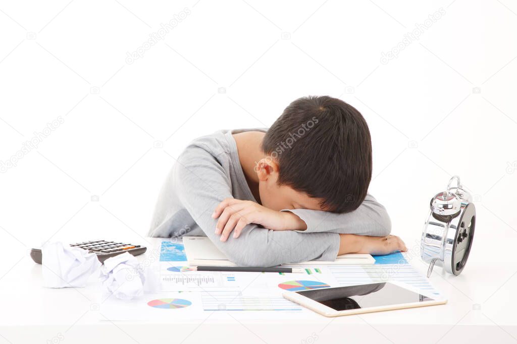 Tired and exhausted asian primary school student. Falling asleep while studying. ISOLATED ON WHTIE BACKGROUND.