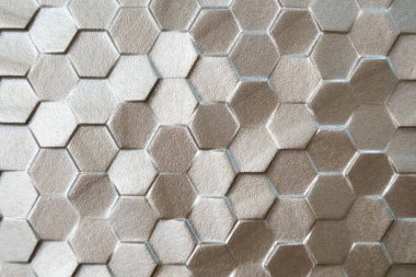 Doku arkaplanı için altın sarısı altıgen mozaik fayanslar.