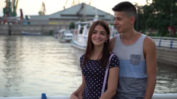 Young Man Embraces His Girl Talks Romantically River Quay Sunset — Stock Video