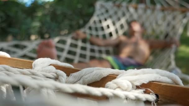 Розслаблений Молодий Чоловік Розтягнутими Ногами Мріє Гамаку Влітку Повільному Русі — стокове відео
