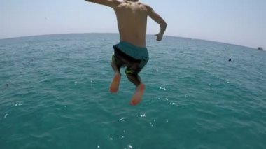 Neşeli adam ahşap bir iskele üzerinde çalışan ayak ilk, ağır çekim klasik ve neşeli genç adam çalıştıran ve ayak ilk ahşap bir iskele yavaş yaz aylarında bluewaters içinde atlama kısa filmlerde sualtı çekim düşen.