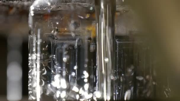 液を注ぐ生産のため工場の瓶やひまわり油の瓶詰め ひまわり油ひまわり油の生産のための高度な工場のコンベア上を移動空ボトルに散水の驚異的なクローズ アップ — ストック動画