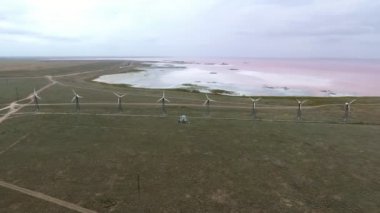Rüzgarın hava Karadeniz üzerinde yaklaşan dron egergy dönüştürücüler çarpıcı kuş bakışı bir satır rüzgar çiftliği türbinleri çok renkli bir gökyüzü ile Karadeniz sahil şeridi üzerinde yaz aylarında yerleştirilen hızlı dönen hayranları ile desteklemek