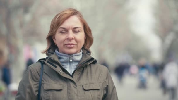 Cheery Blond Woman Sportive Green Jacket Walking Park Slow Motion — Stock Video