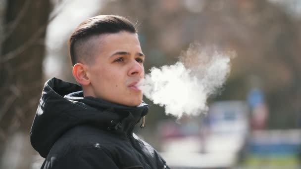 Confident Young Man Smoking Cigarette Breathing Out Fume Clouds Spring — Stock Video