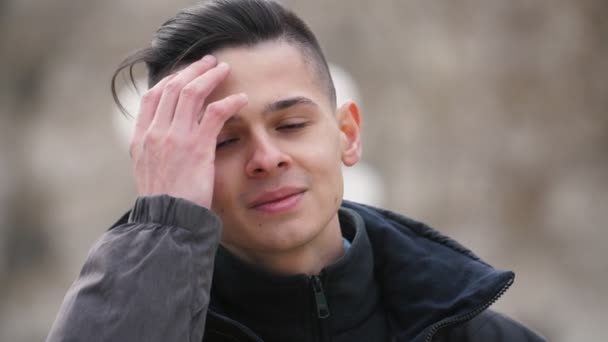 Cheery Young Man Putting His Hair Order Outdoors Spring Slow — Stock Video