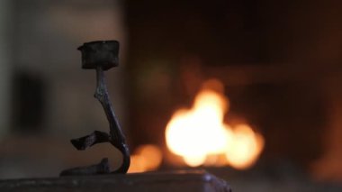 Bir demirci atölyesinde ateşile bir demirci demir ilham verici bir ferforje harika görünümü içinde bir demirci atölyesinde bir örs üzerinde duran azgın bir ocak güzel yaprakları ile gül.