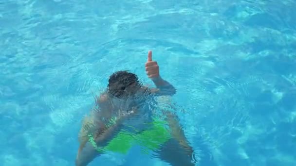 Small Boy Sitting Underwater Showing Thumb Sign Swimming Pool Slo — Stock Video