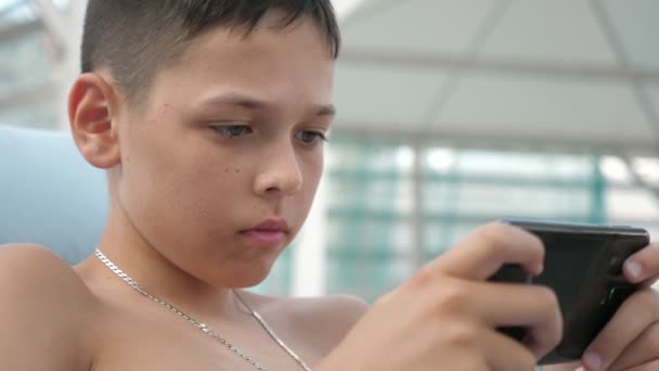 Small Boy Playing Video Games His Phone Sitting Seashore Summer — Stock Video