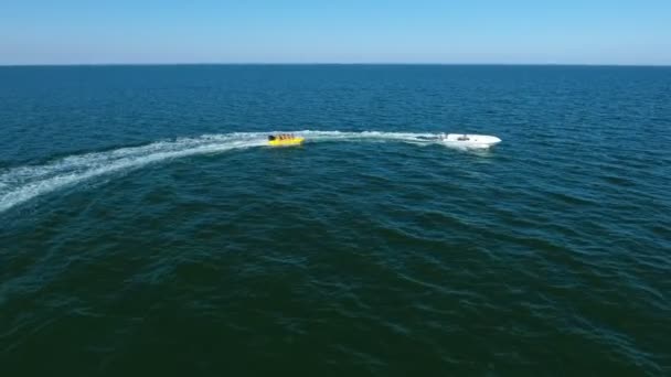 Aerial Shot White Boat Towing Banana Happy Tourits Open Sea — Stock Video