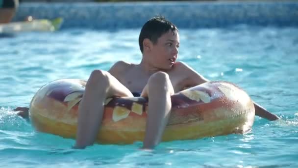 Smart Brunet Boy Smiling Sitting Water Tube Swimming Pool Slow — Stock Video