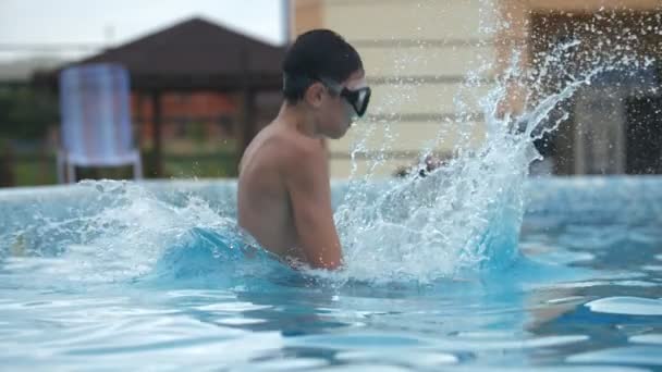 Happy Boy Diving Feet First Pool Splashes Summer Slow Motion — Vídeo de stock