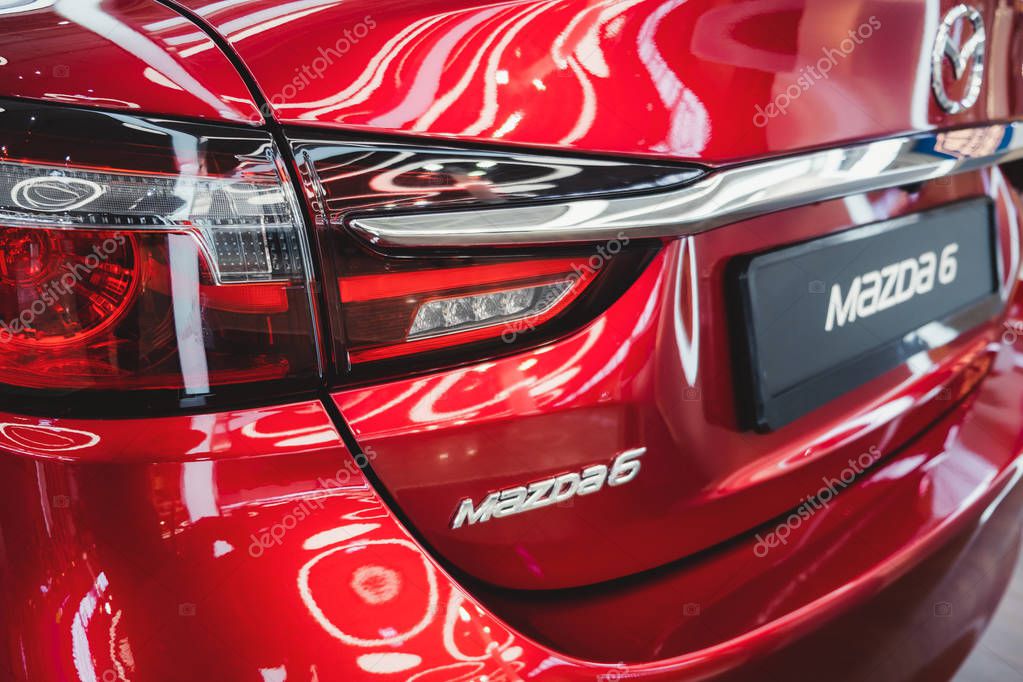 ST. PETERSBURG, RUSSIA - MARCH, 2019: Logo of Mazda car model 6, Modern design of red car and tail light.