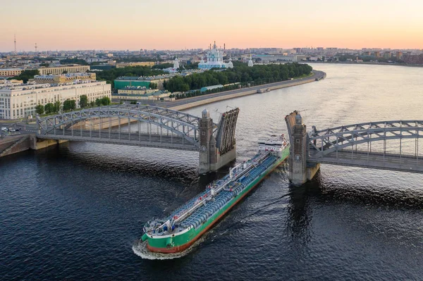 Санкт-Петербург. Россия. Большеохтинский мост поднят. Мост Петра Великого на закате. Разводные мосты Петербурга. Навигация по Неве. Города России. Панорама Санкт-Петербурга . — стоковое фото