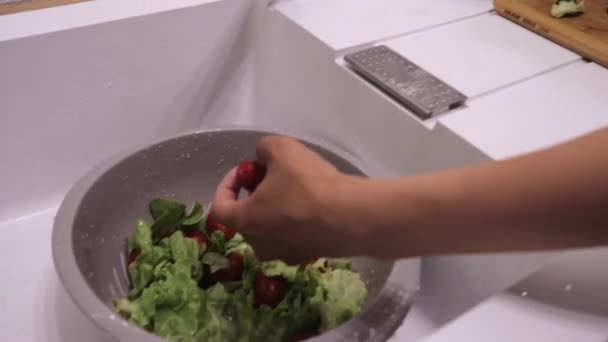 Washing vegetables under the tap board with a knife close up, tomatoes and cucumbers — Stock Video