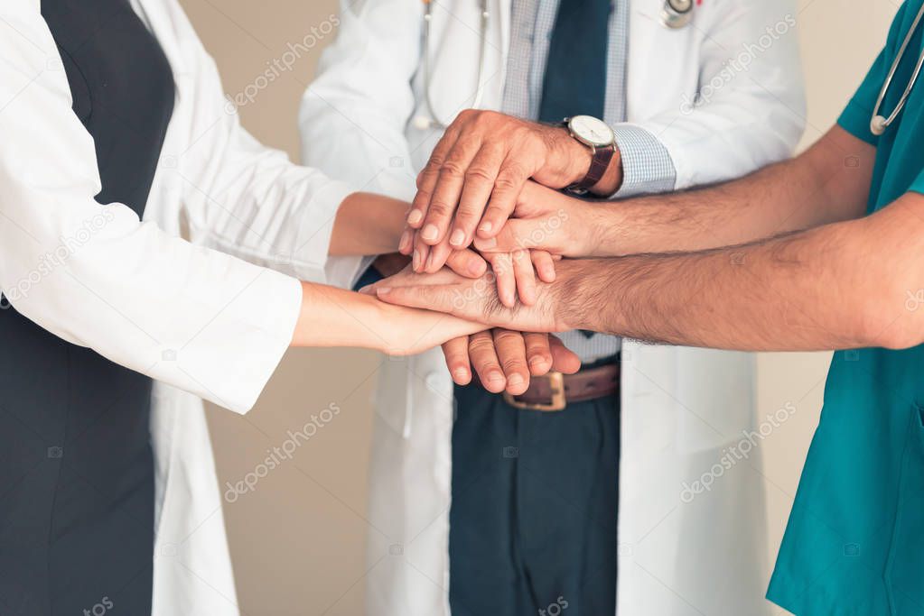 Portrait of doctor team joining hands stacking and handshake together., Unity and teamwork concept.